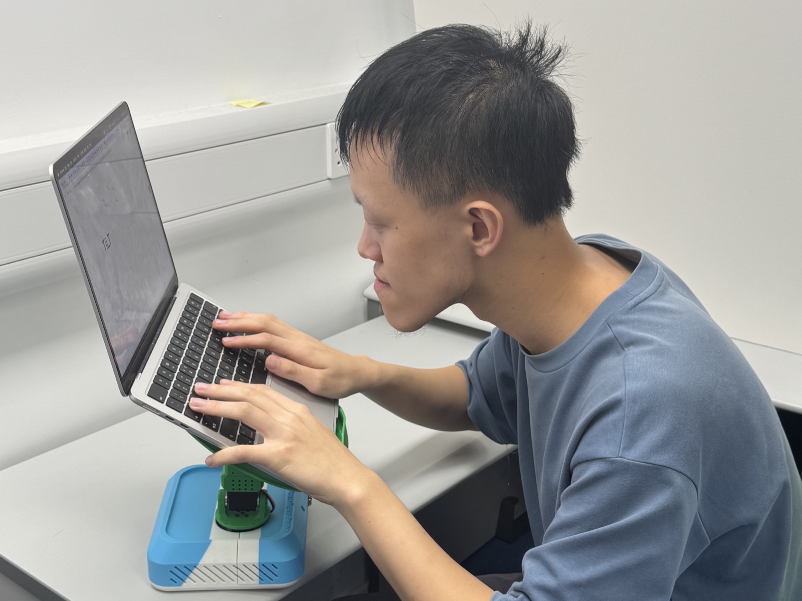 A user begins to slump over a laptop