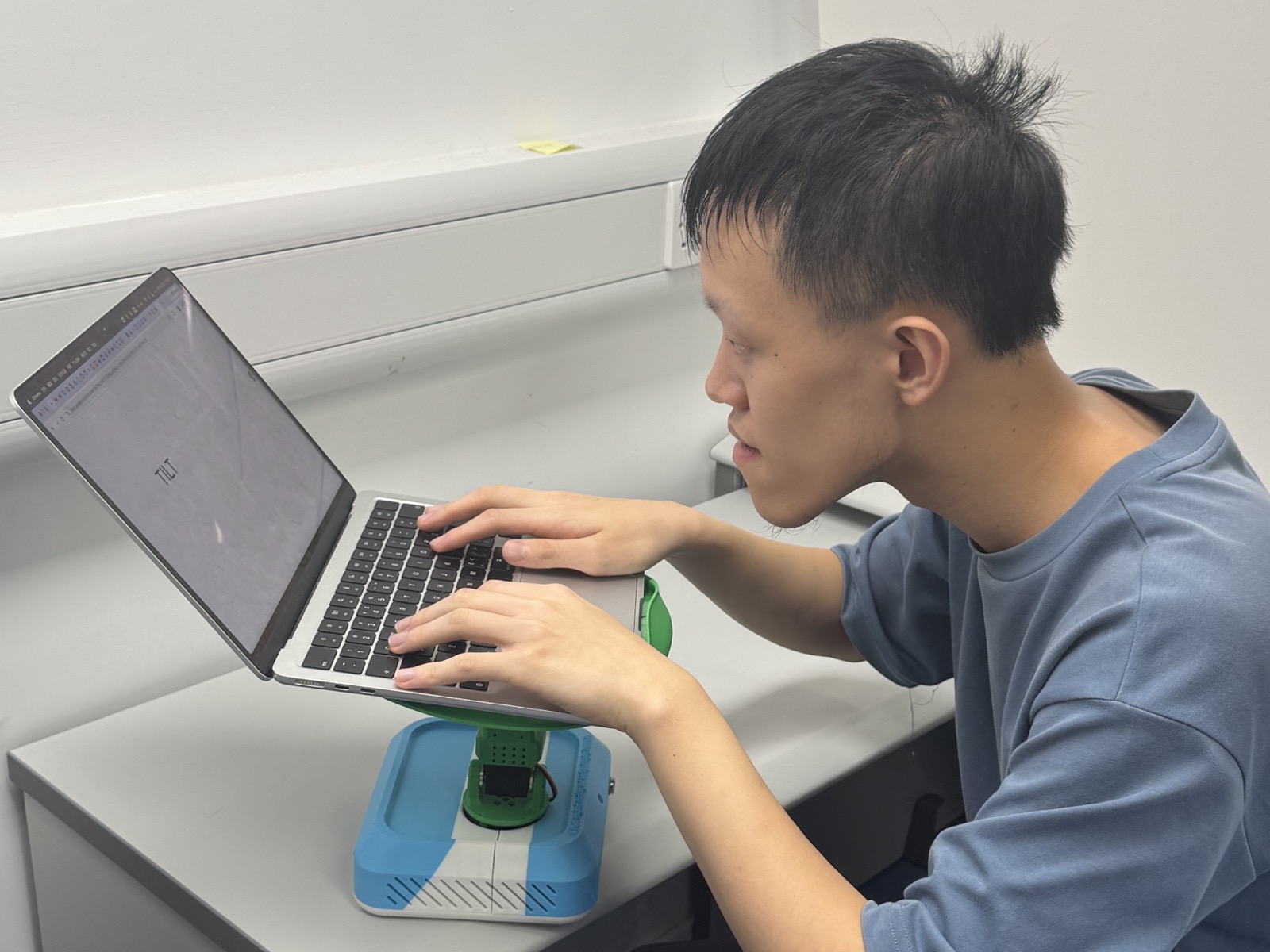 TILT raises the laptop display in response to slumping