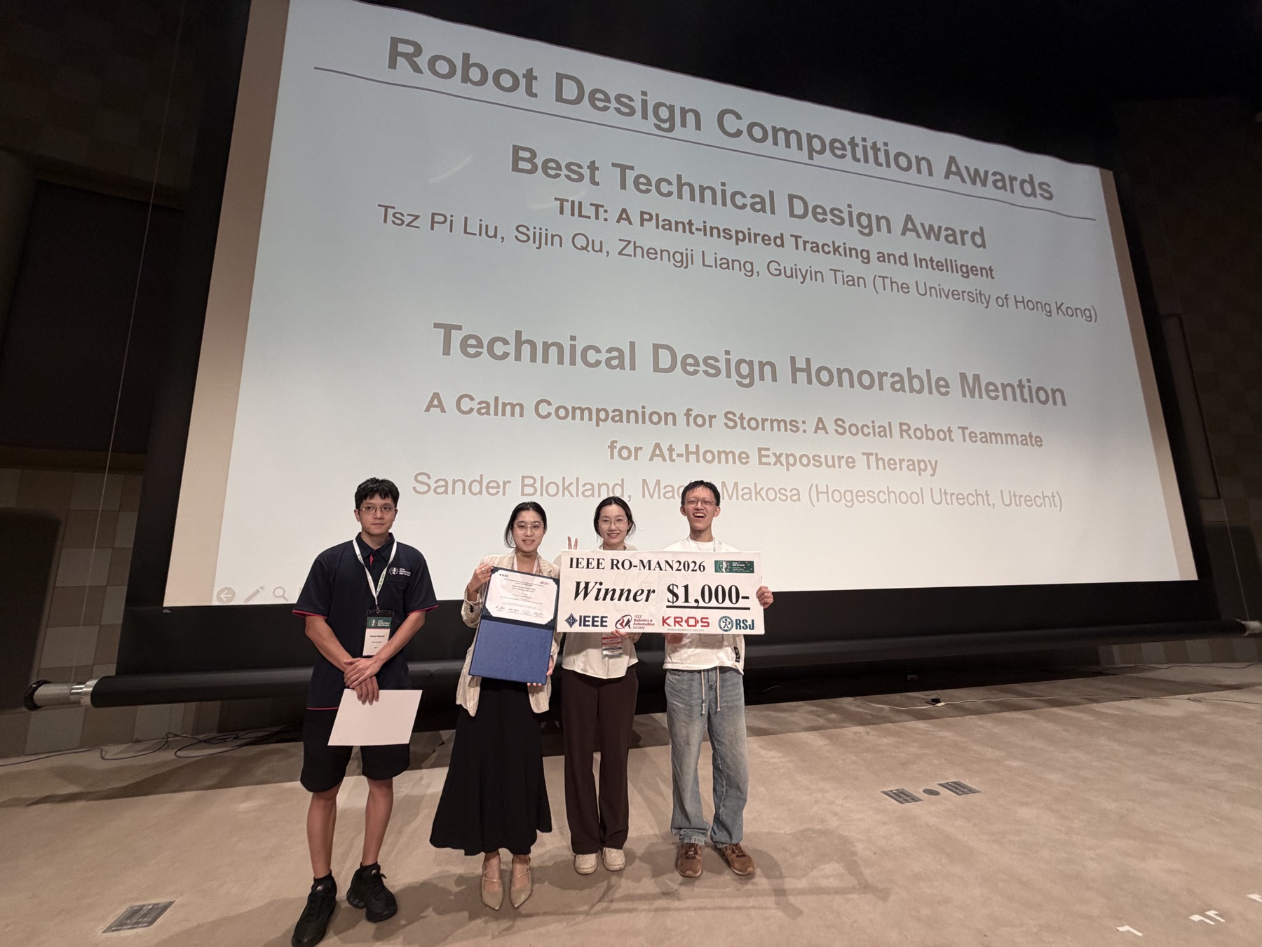 The TILT team receiving the Best Technical Design Award at IEEE RO-MAN 2026